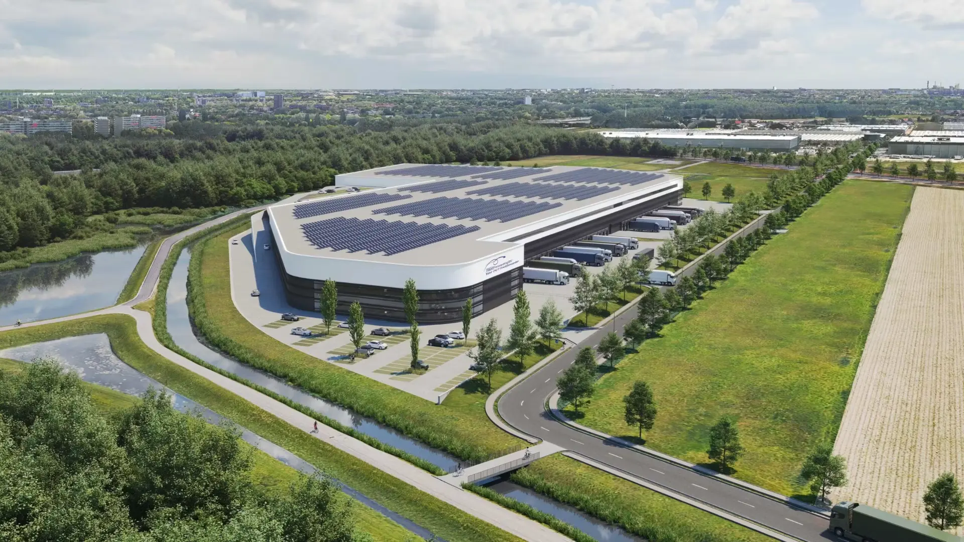 Aerial view of the modern R&M distribution centre with solar panels on the roof, loading docks and green surroundings